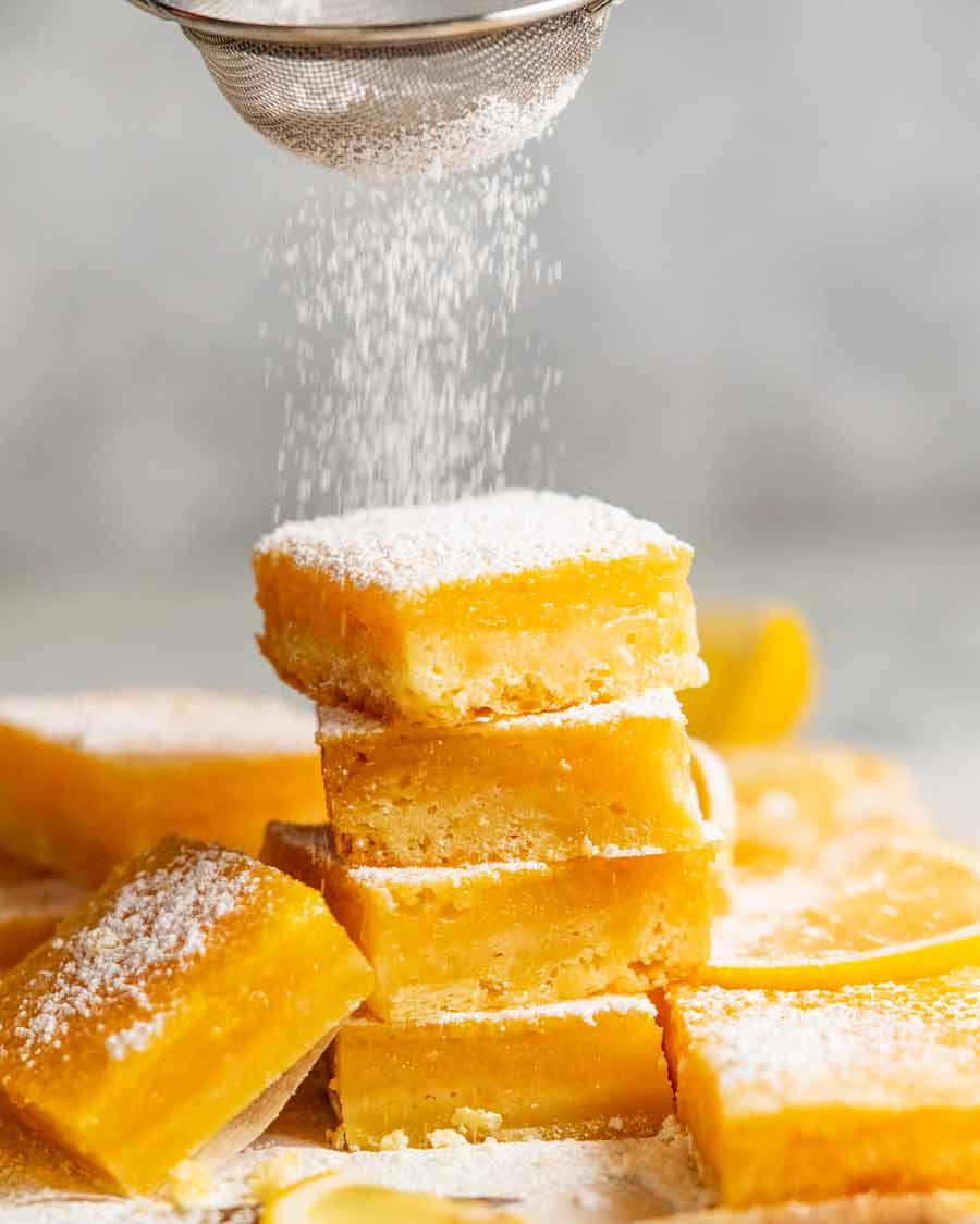 Dusting Easy Lemon Bars with icing sugar