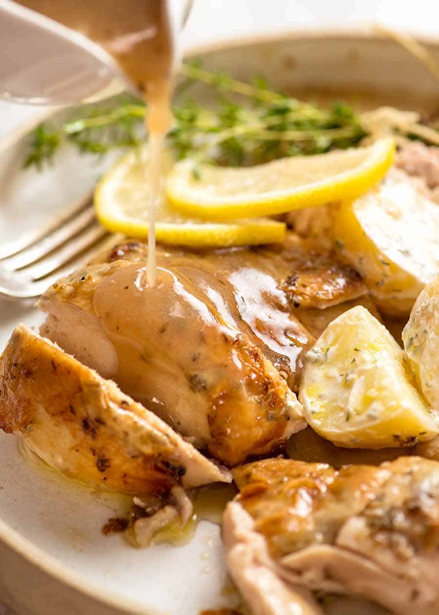 Lemon Sauce being poured over Slow Cooker Roast Chicken