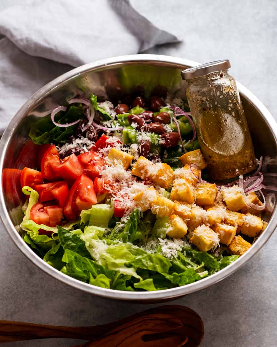 Mega Italian Salad ingredients in a bowl ready to be tossed