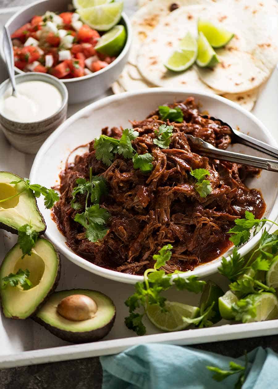 Mexican Shredded Beef taco spread - tortillas, sour cream, avocado, lime, pico de Gallo