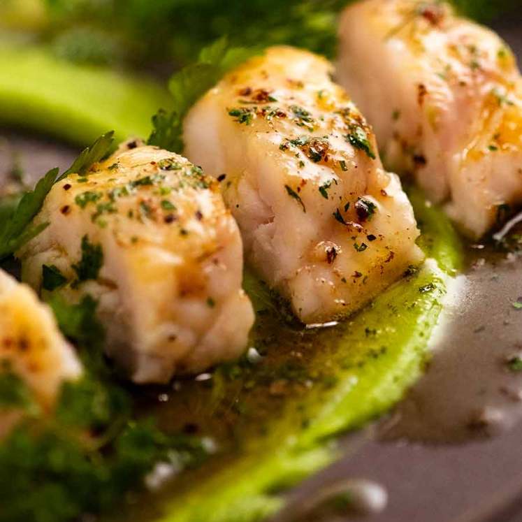 Close up photo of Monkfish recipe with pea puree and herb brown butter