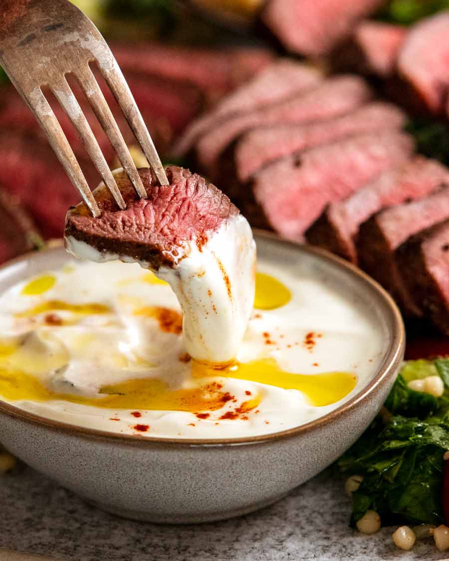 Dipping Moroccan lamb backstrap in yogurt sauce