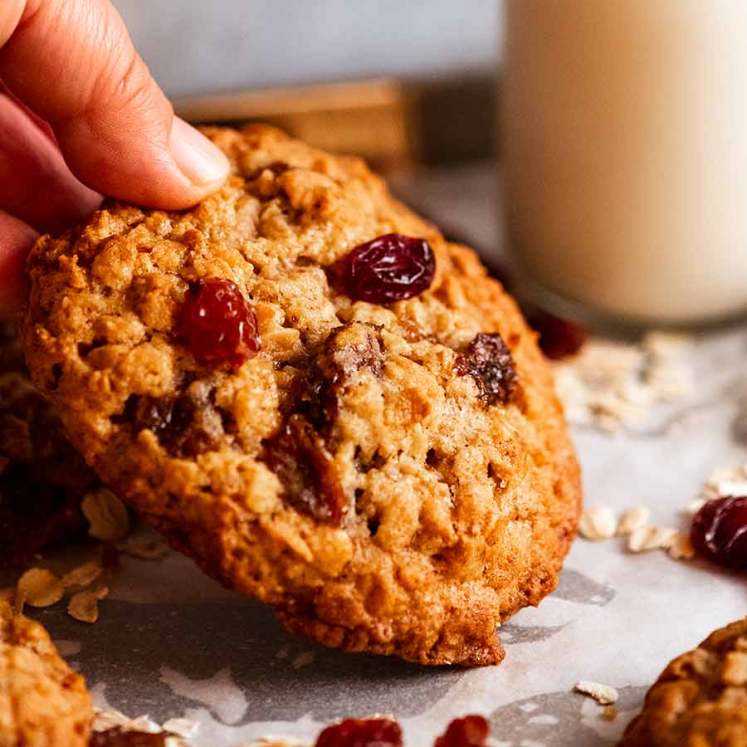 Hand picking up Oatmeal Raisin Cookies