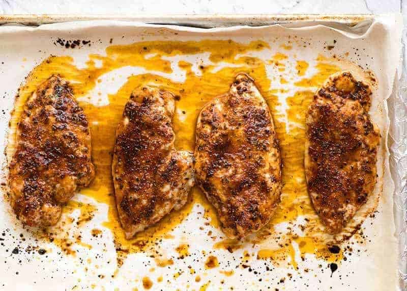 Overhead photo of Juicy Oven Baked Chicken Breast on a tray, fresh out of the oven