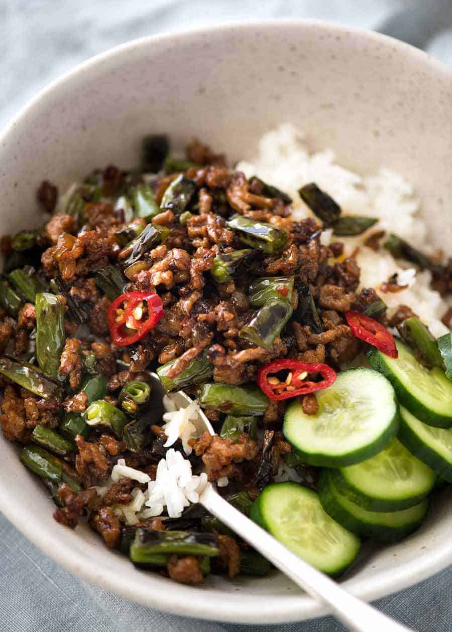 Pork Stir Fry with Green Beans over rice in a rustic bowl, ready to be served