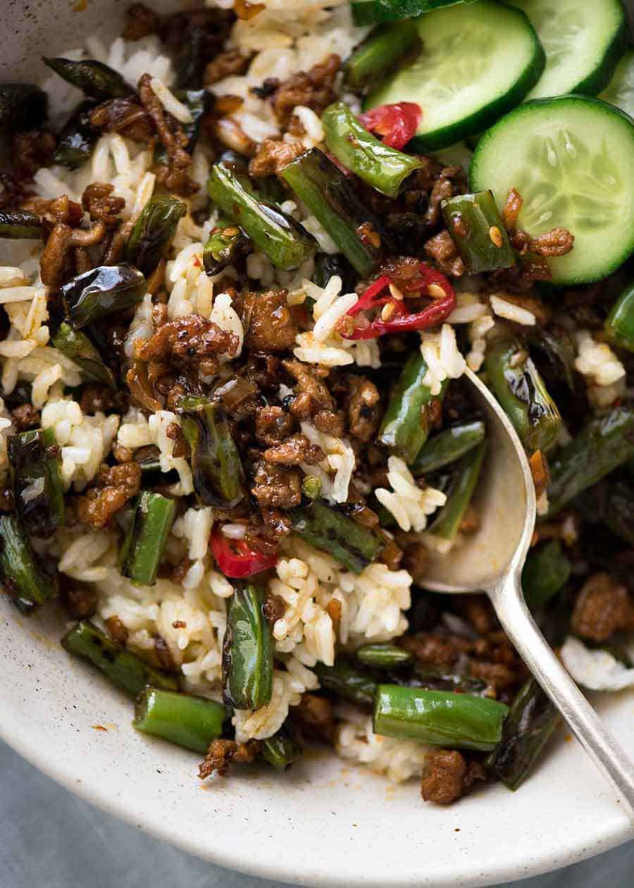 Close up of Pork Stir Fry with Green Beans mixed with rice, ready to be eaten