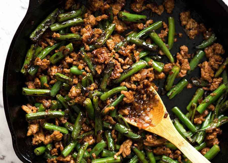 Overhead photo of Pork Stir Fry with Green Beans in a black skillet, fresh off the stove