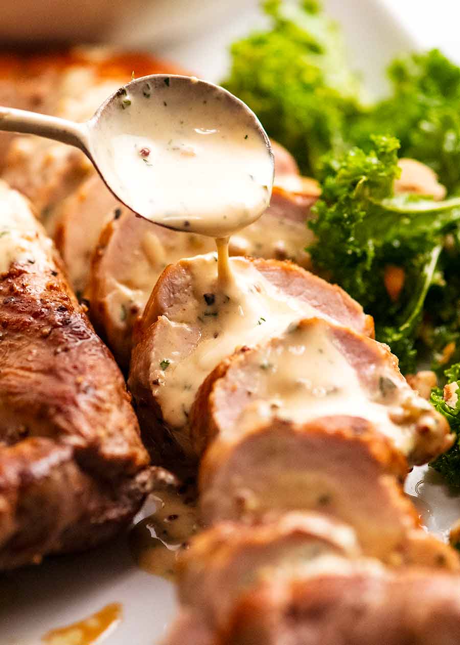 Spooning Creamy Mustard Sauce over Pork Tenderloin