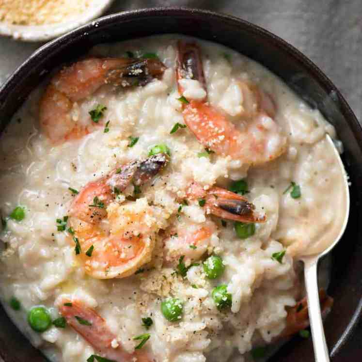 Overhead photo of Prawn Risotto (Shrimp Risotto) in a dark brown bowl, ready to be eaten.