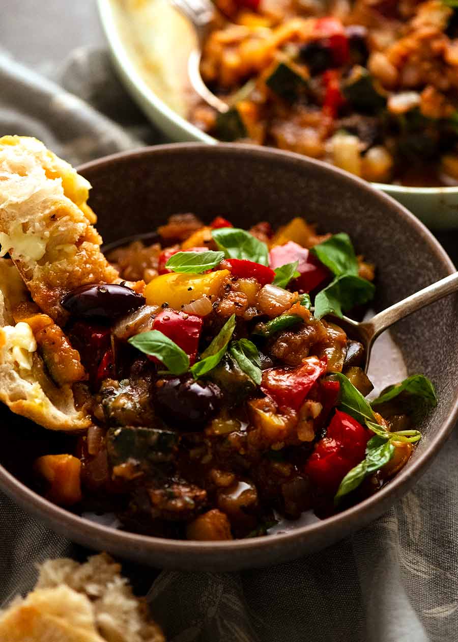 Ratatouille in a bowl with a side of crusty bread