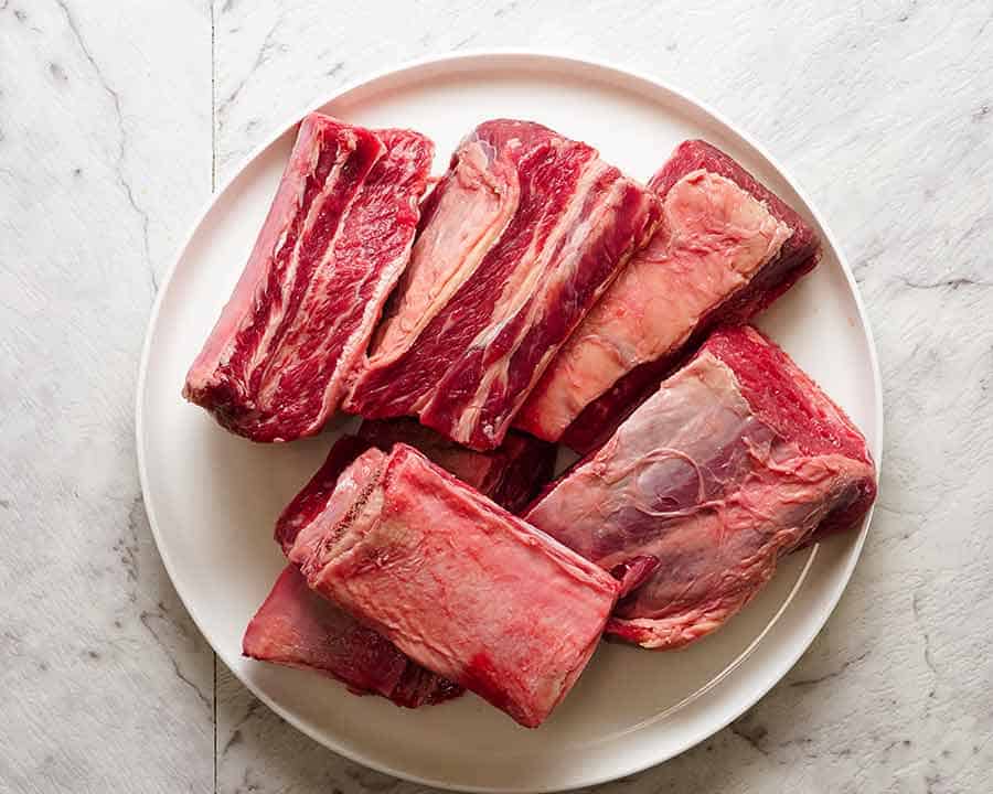 A plate with raw beef short ribs