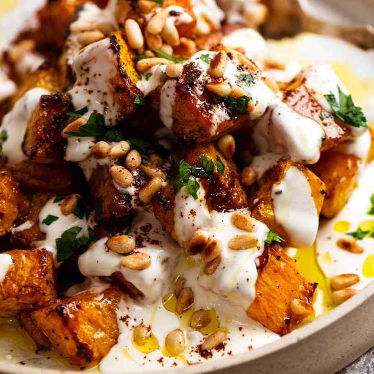 Roast Pumpkin with Yogurt Sauce and Pine Nuts on a plate, freshly made