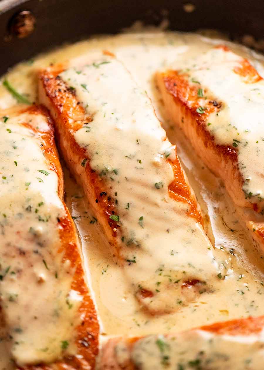 Close up of Creamy Herb & Garlic Salmon Sauce in a skillet, fresh off the stove