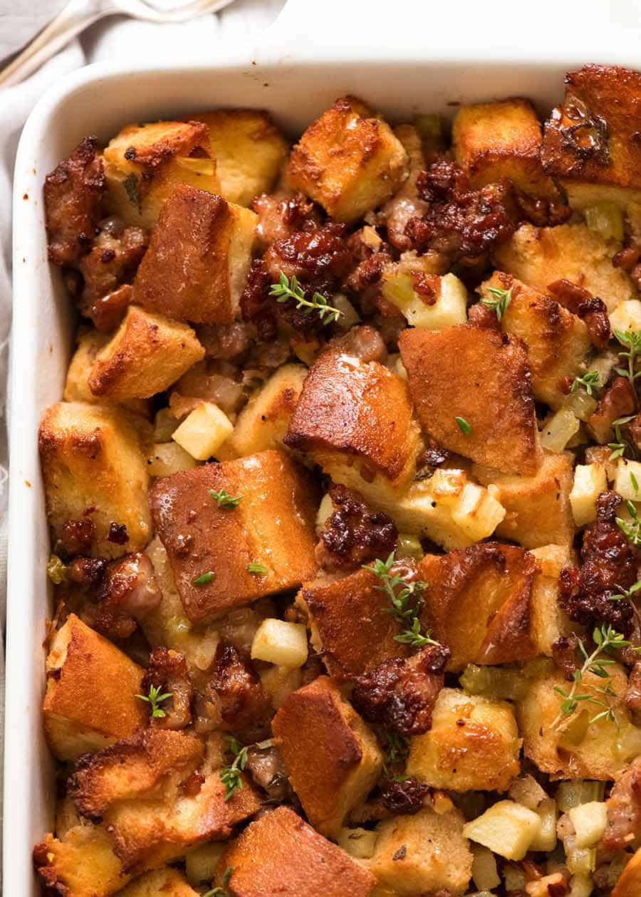 Close up of Sausage Stuffing recipe in a white baking dish, fresh out of the oven ready to be served