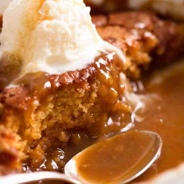 Close up of Self Saucing Butterscotch Pudding in a baking dish, being served