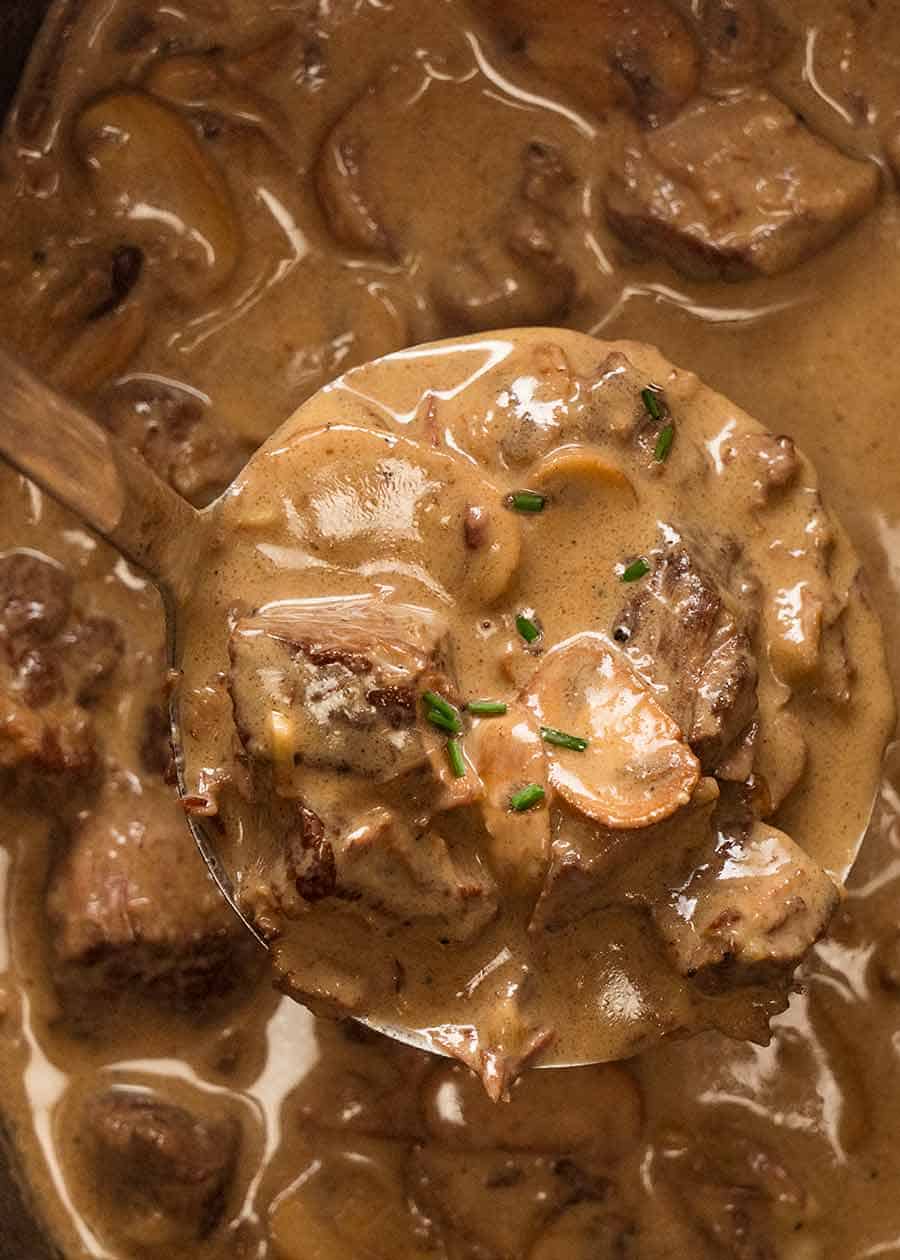 Close up of ladle scooping up Slow Cooker Beef Stroganoff