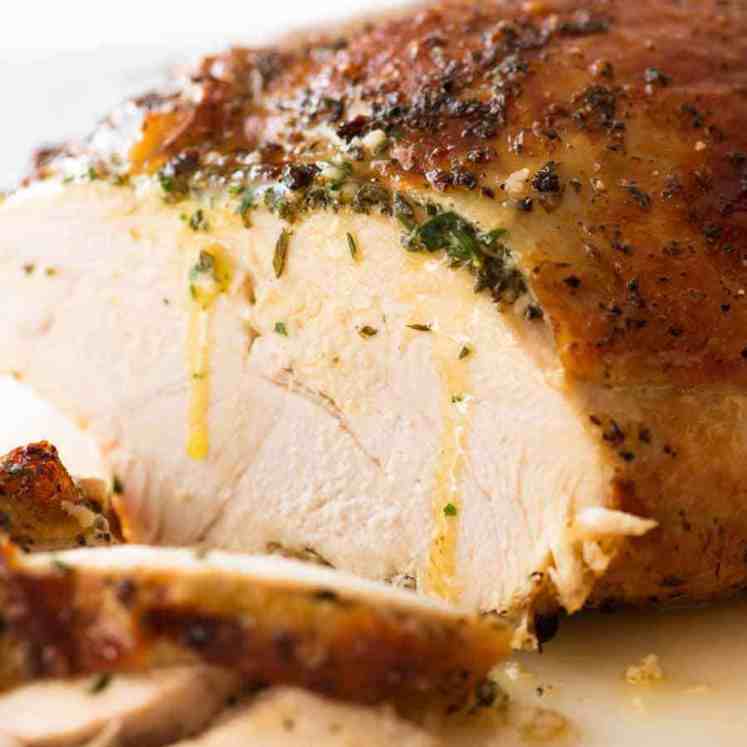 Sliced Garlic Herb Slow Cooker Turkey Breast with butter dripping down