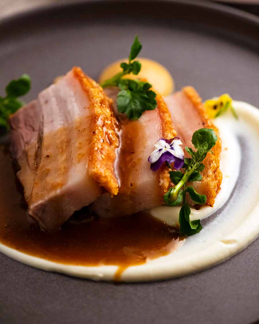 Fine dining restaurant plating of Slow Roasted Crispy Pork Belly