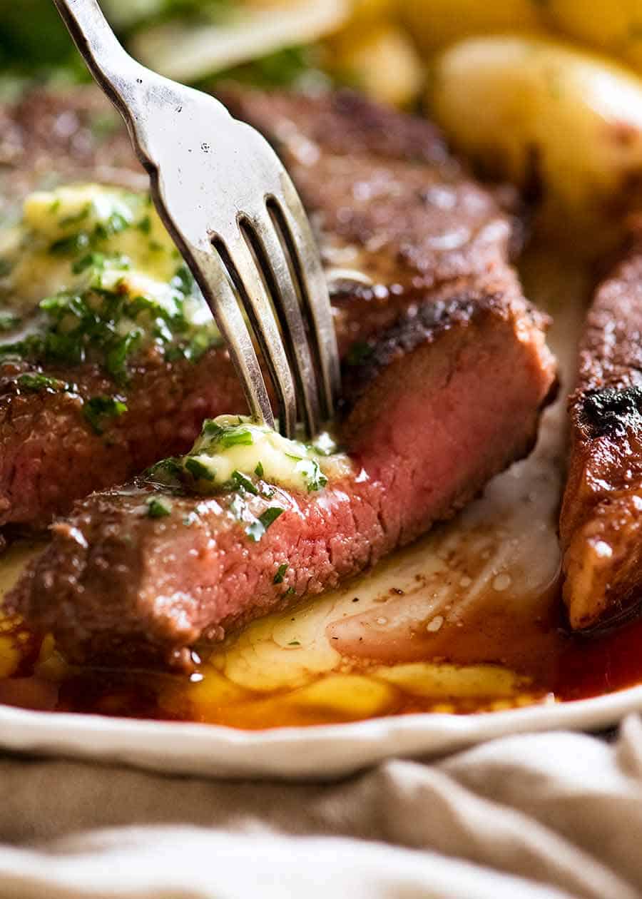 Close up of fork picking up slice of steak after using Steak Marinade