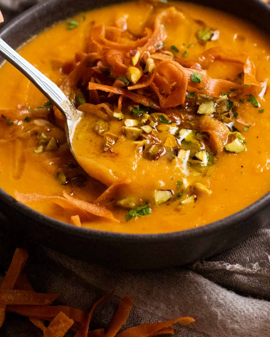 Spoon eating sweet potato soup