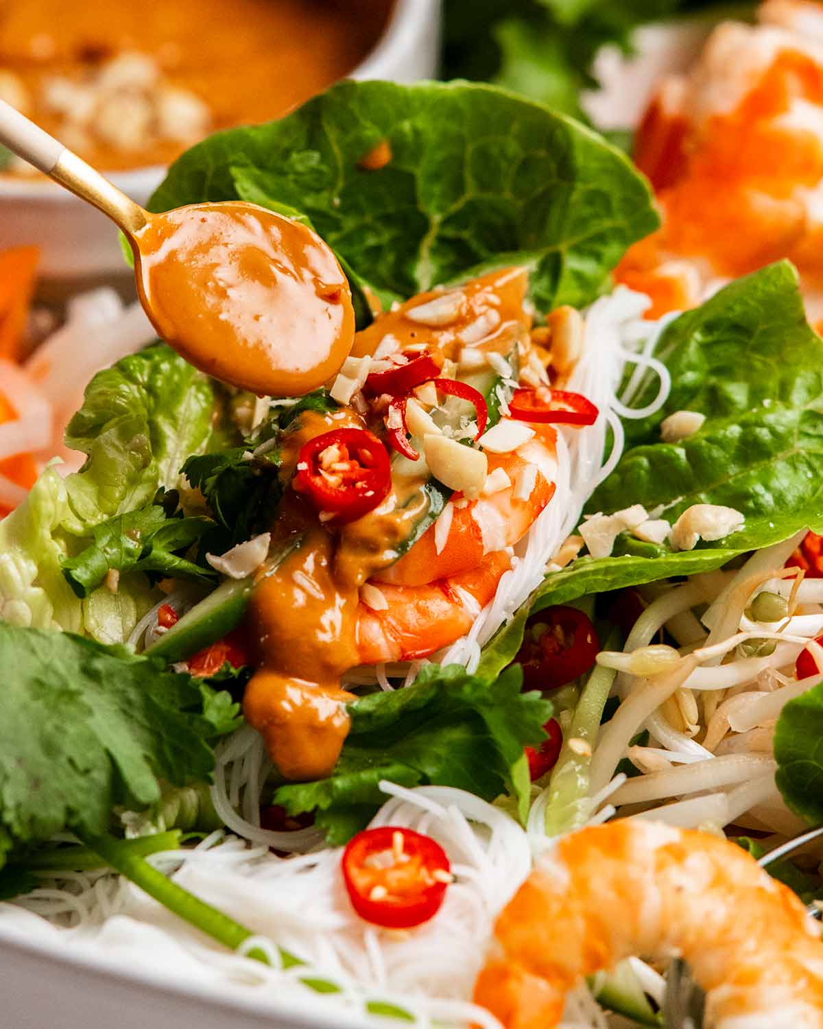 Drizzling sauce on Vietnamese lettuce wraps